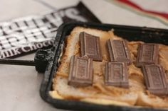 there are chocolate bars on top of toasted bread in the baking pan, ready to be eaten