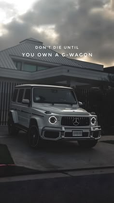 a mercedes g - wagon parked in front of a house with the words don't die until you own a c - wagon