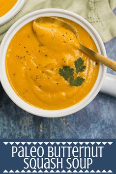 two white bowls filled with soup on top of a blue table cloth and the words paleo butternut squash soup