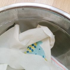 a cloth is sitting in the bottom of a metal bowl