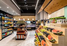 a grocery store filled with lots of fresh fruits and veggies on display next to shelves