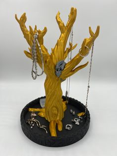 a yellow figurine with chains hanging from it's trunk