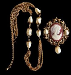 This stunning Kenneth Jay Lane Avon Poetic Romance Cameo Faux Pearl Pin Pendant Necklace is a timeless piece of jewelry that will never go out of style. With a beautiful round rhinestone as the main stone, this necklace features a cameo shape and is made of antique gold tone metal. The necklace is 24 inches long and the brooch is 3 inches big, making it adjustable to fit any size. This vintage necklace is signed and comes with a certificate of authenticity. It is perfect for any occasion, whethe Elegant Cameo Necklace For Formal Occasions, Elegant Evening Cameo Necklace, Elegant Evening Jewelry With Cameo Detail, Poetic Romance, Antique Cameo Jewelry, Vintage Jewelry Antique, Pearl Pin, Fashion Sketchbook, Cameo Jewelry