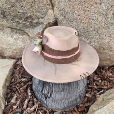 "The Mae is pretty in pink... with beige tones. Simple and pretty is The Mae! Handmade Fedora hats with Western style bling. All hats are ONE OF A KIND and designed personally by myself. Purposely aged to add lots of character! I enjoy creating unique items for others to enjoy in this mass produced world. Be UNIQUE... stand out in the crowd!  All hats are made to fit differently- this hat measures about 23\" with a tie to make adjustments allowing you to tighten the fit." Pink Wide Brim Hat For Rodeo, Western Pink Hat With Curved Brim, Western Style Pink Hat With Curved Brim, Pink Brimmed Hat For Rodeo, Pink Short Brim Straw Hat For Rodeo, Pink Curved Brim Hat For Rodeo, Pink Straw Hat With Curved Brim For Rodeo, Pink Flat Brim Hat For Country Events, Pink Western Sun Hat With Curved Brim