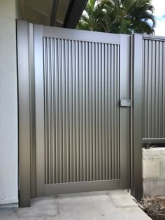 a large metal gate with vertical slats on it's sides and an opening at the top