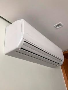 an air conditioner is hanging on the wall