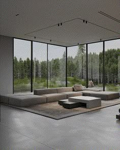 a large living room with lots of windows and furniture on the floor in front of it