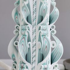 an intricately designed vase sitting on top of a table