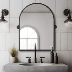 a bathroom sink sitting under a large mirror next to a wall mounted faucet