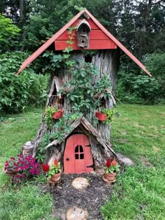 a tree stump house with plants growing out of it