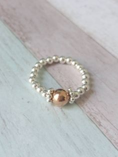 Fabulous handmade Sterling Silver & Rose Gold Filled Stretch Ring.  This ring is truely beautiful. I have matching bracelets and necklaces.  ⭐ 3mm Sterling Silver Beads  ⭐6mm Rose Gold Filled Bead ⭐Sterling Silver Daisy Spacers  Measuring your ring finger: wrap a length of cotton around the finger where you would like the ring to sit, then measure the cotton from end to end to get the circumference / size you need to order.  All of my rings and bracelets are hand threaded on high quality, strong Silver Heart Bracelet, Sterling Silver Bead Bracelet, Silver Toe Rings, Beaded Ring, Stretch Ring, Silver Bead Bracelet, Silver Stacking Rings, Gift For Her Birthday, Ring Stacking