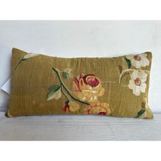 an embroidered pillow with flowers on it