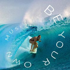 a woman riding a wave on top of a surfboard in front of a blue ocean