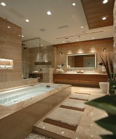 a bathroom with a large jacuzzi tub next to a walk in shower