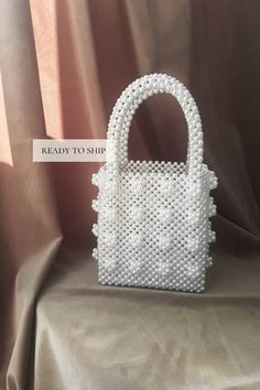 Shrimps bag Aesthetic tote bag for woman. Vintage pearl beaded white retro bag that will decorate your wedding day. Amazing wedding gift for bride. SIZE: *Height: 33 cm *Height without handles: 19 cm *Width: 16.5 cm *Lateral width: 10 cm *Handle drop: 14 cm *Weight: 750g 🔥PROCESSING TIME 3-4 days MATERIAL: white acrylic pearl beads 8mm. LINING White satin🤎 The bag can be made with a LINING with a POCKET or without a lining. Choose VARIATIONS when you place an order☝ With every pearl bag you'll get jewelry GIFT - beaded jewelry🎁 In addition to the gift, a hand-signed POSTCARD with a message from the purse is attached to the order✉ If this is a present, be sure to write me the name of the recipient✒ More pearl bags: https://www.etsy.com/shop/VitakaJewelry?ref=seller-platform-mcnav§ion_id= Gold Chain Handbag, Wedding Tote Bag, Woman Aesthetic, Aesthetic Tote Bag, Wedding Tote, Retro Bags, Wedding Purse, Bridal Clutch, Wedding Gifts For Bride