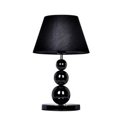 a black lamp with three balls on it and a black shade over the top of the lamp