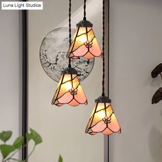 three lights hanging from a ceiling in a room