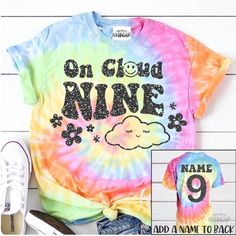 a tie dye shirt with the words on cloud nine and an image of a pair of shoes