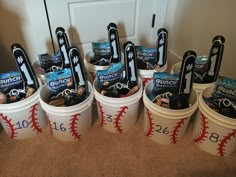 buckets filled with baseball snacks sitting on the floor