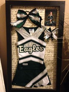 an eagles cheer uniform is displayed in a shadow box