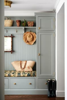 a bench with a hat on top of it in front of a bookcase and shelves