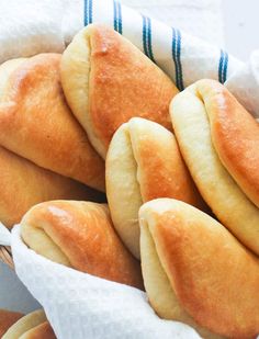 a basket full of bread rolls sitting on top of a table