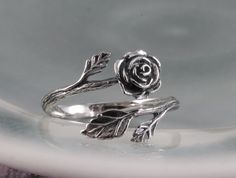 "This sterling silver rose ring is beautifully sculptural. It's oxidized to show the graceful flow of each petal. The rose is considered the \"Queen of all Flowers\"  and has been cultivated for thousands of years for its magnificent beauty and scent. A wonderful gift of love, or for one who loves the beauty of nature. This ring, as shown, is a size 7 and is fully adjustable. If you have a specific size in mind, please leave a note and I will re-size it for you." Rose Sterling Silver Promise Ring, Sterling Silver Rose Flower Ring With Rose Design, Sterling Silver Rose Flower Jewelry, Silver Rose Design Jewelry For Promise Ring, Silver Rose Detail Sterling Silver Jewelry, Adjustable Sterling Silver Flower Ring With Rose Design, Adjustable Sterling Silver Rose Design Ring, Silver Rose Ring Jewelry, Sterling Silver Rose Design Flower Ring