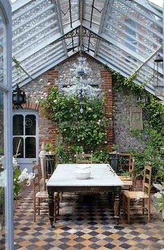 an outdoor dining area with table and chairs