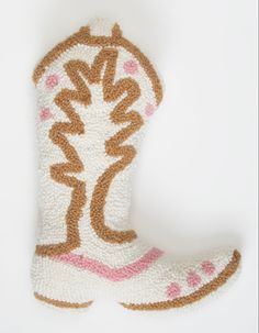 a pair of white and brown boots with pink trims on the bottom, against a white background