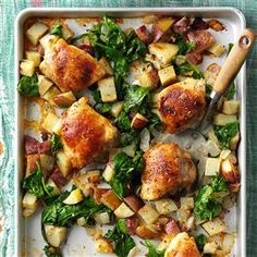 chicken and potatoes with spinach in a casserole dish on a green tablecloth