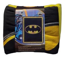 the batman pillow is on display in front of a white background and yellow trimmings