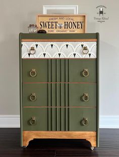 a green cabinet sitting on top of a hard wood floor