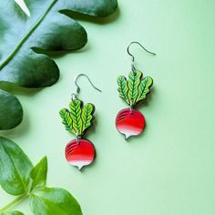 These cute radish earrings are inspired by the "Sparkler" radish or breakfast radish varieties with their distinctive vivid coloring and plump roundness. These original earrings are hand painted on cherry wood with two separate pieces, etched details, and a gorgeous ombre of bright red to white. Lightweight and cute, these radishes are a fun addition to your wardrobe and a great gift for a gardener or fan of Luna Lovegood. Option 1: Silver Ear WiresThese earrings feature silver hypoallergenic 304 stainless steel ear wires. Option 2: Gold Ear WiresThese earrings feature gold hypoallergenic 304 stainless steel ear wiresOption 3: Silver Ball PostsThese earrings feature 4mm silver-plated brass ball posts with butterfly backs.Option 4: Gold Ball PostsThese earrings feature 4mm 24k gold-plated b Radish Earrings, Kraft Gift Boxes, Luna Lovegood, Radishes, Gift Card Shop, Wooden Jewelry, Cherry Wood, Plastic Free, Bright Red