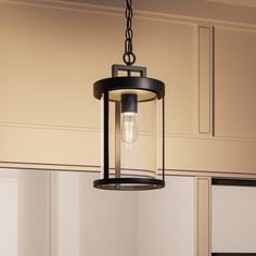 a light fixture hanging from the ceiling in a kitchen