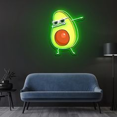 an avocado with sunglasses on its face is lit up in the dark room