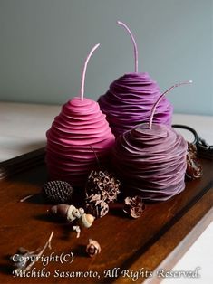 two purple vases sitting on top of a wooden table