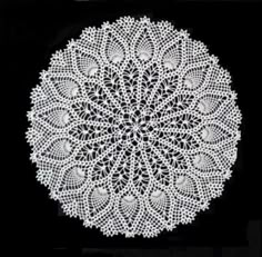 a white doily on a black background