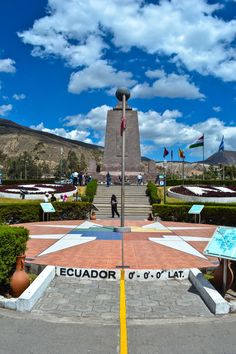 the monument is surrounded by flags and flowers