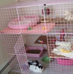 a pink cage filled with lots of stuffed animals