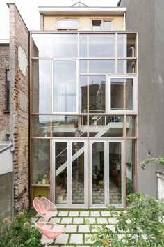 an outside view of a house with large windows