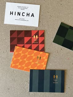 three different colored business cards sitting on top of a table