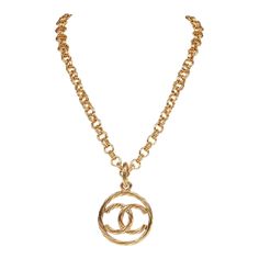 This vintage 93P necklace is in gold plated metal featuring a classic encircled CC pendant, long link chain, and a springring closure. Origin: France Condition: Vintage; Excellent - this necklace shows mild signs of wear, including light brushing, faint pitting, and some areas of patina. Accompanied by: Chanel box Measurements: 28" chain, 1.8" pendant Necklace Gold Chanel, Chanel Cc Necklace Gold, Chanel Box, Signature Quilts, Gold Long Necklace, Chanel 2, Brushing, Vintage Chanel, Fendi Bags