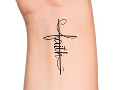 a woman's wrist tattoo with the word faith written in cursive writing