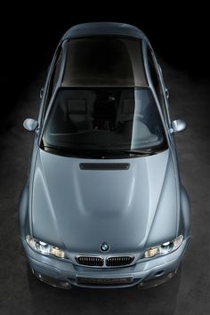 the front end of a silver car with its hood up