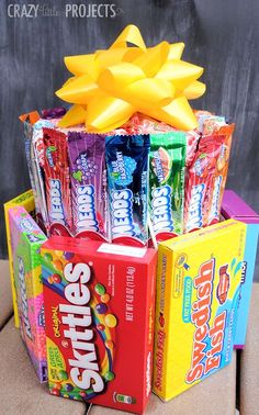 an assortment of candy bars and candies are stacked on top of each other in a gift box