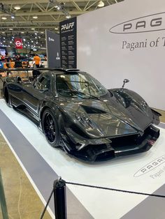 a black sports car is on display at an auto show