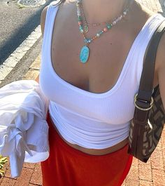 orange midi skirt white ribbed tank top brown shoulder purse turquoise pendant beaded necklace, fall fashion, fall aesthetic, it girl aesthetic, orange skirt outfit ideas, trendy fall fashion, womens clothing Orange Skirt Outfit, Skirt Fall Outfit, Outfit Ideas Trendy, White Ribbed Tank Top, Orange Midi Skirt, Midi Skirt White, Skirt Outfit Ideas, Trendy Fall Fashion