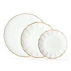 three white and gold dinner plates