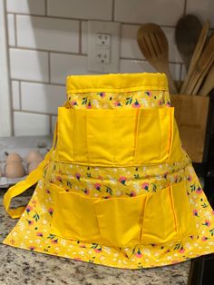 a yellow sun hat sitting on top of a kitchen counter next to a knife holder