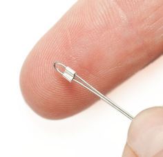 a finger with a needle in the middle of it